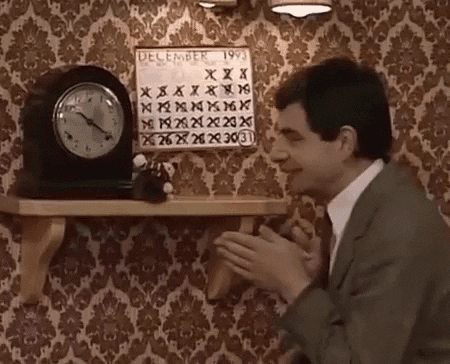 Gif of Mr. Bean showing a calendar to a stuffed animal. 
