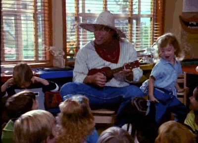 Gif of a teacher playing the ukelele for a class of students.