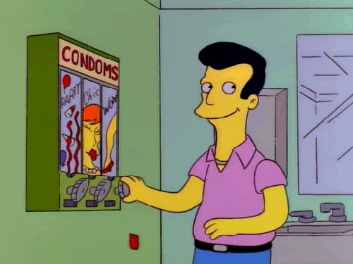 A man gets condoms from a machine