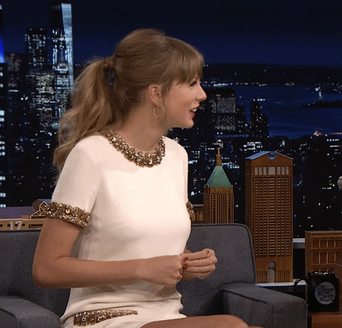 Taylor Swift happily dancing on the Tonight Show with Jimmy Fallon.