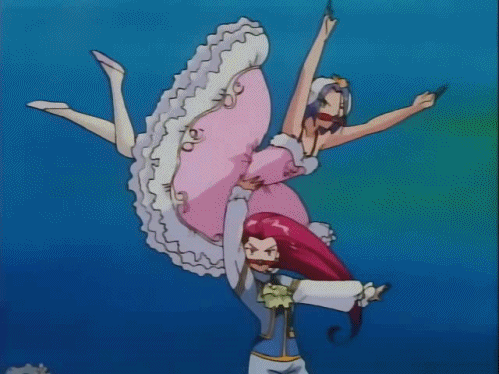 Jessie and James dancing underwater; Jessie is wearing a masculine suit, and James is wearing a pink dress. A red 'R' descends behind them as Jessie holds James aloft.