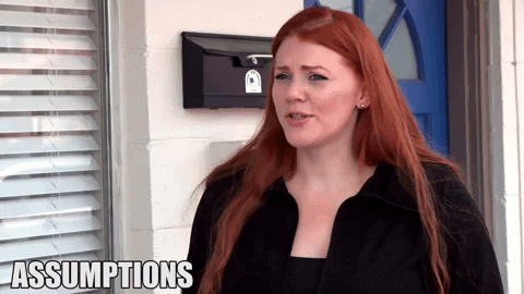 GIF of red-headed woman saying "Assumptions make you look like an ass."