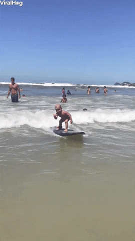 kid surfing with a shaka