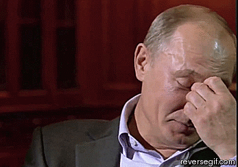 Vladimir Putin laughing during an interview. 