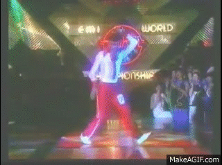 A person in a white tank top dancing energetically with the text 'Born to Be Alive' in a GIF from Born in East L.A.