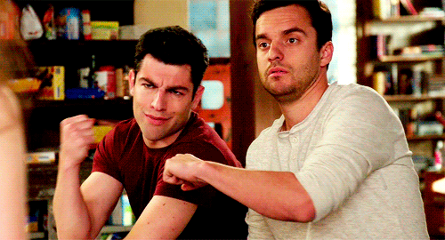 Two best mates from TV show New Girl fist bumping