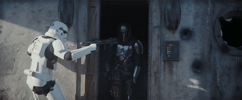 Gif of The Mandalorian, shooting his way out of a building past Stormtroopers