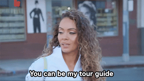 Gif of woman saying "you can be my tour guide"