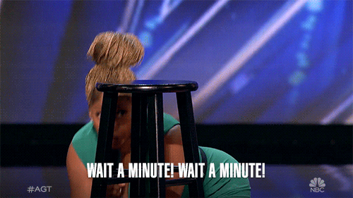 Woman on America's Got Talent popping up behind a wooden stool saying "Wait a minute! Wait a minute!"