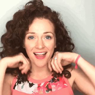 woman proud of her curly short hair