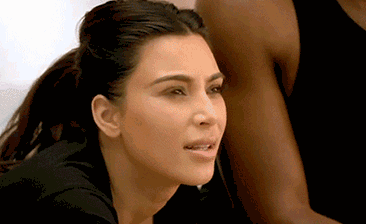 Kim Kardashian looks really confused. She turns towards Kanye West who has a blank expression and shakes his head