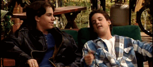 Gif of a scene from TV show "Boy Meets World" showing two friends fist pounding