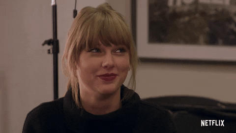 Gif of Taylor Swift smiling and scrunching her nose