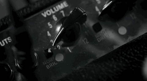 GIF of a close-up of a finger turning up the volume knob on a guitar amplifier.