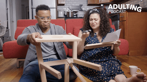 Gif of frustrated Black man and woman trying to build a DIY stool
