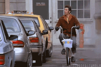 Kramer from Senfeld riding his bike.