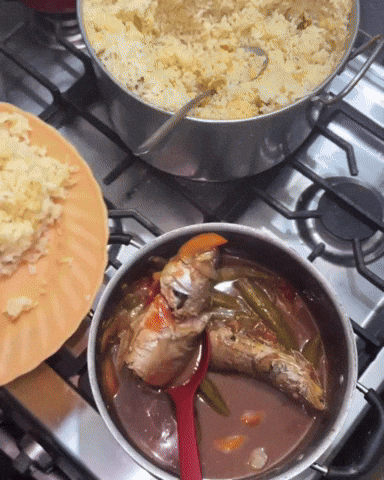 A pot of cooked rice next to a pot of stew on a home stove