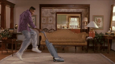 man vacuuming happily