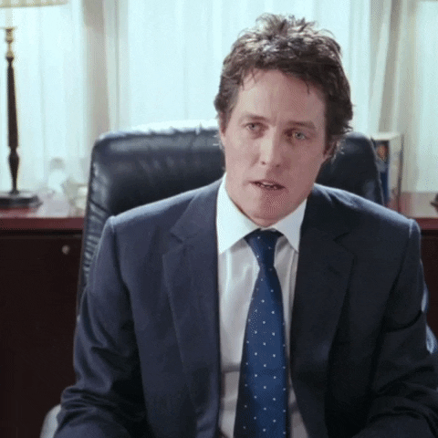 Image of handsome British actor I've forgotten the name of (maybe Hugh Grant?) thunking his head into the desk.
