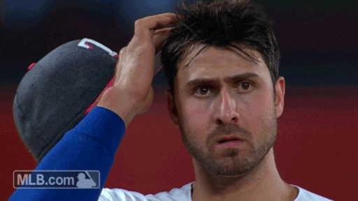 baseball player scratching his head