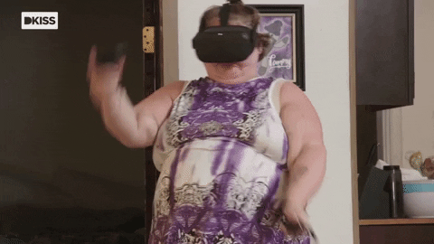 A woman with a VR headset on moving her arms rapidly forward and back.