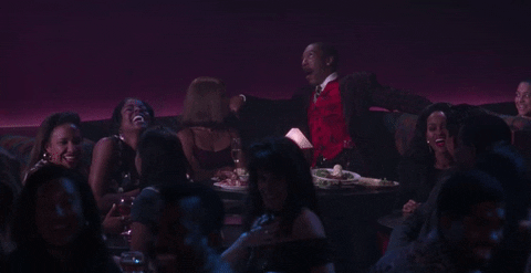 The text acronym LMAO explained in this gif of a table of people laughing