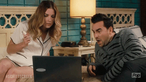 Brother and sister looking at laptop GIF.