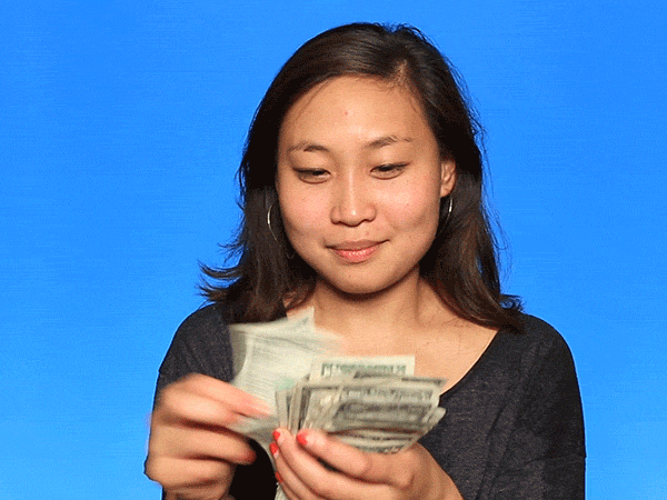 asian woman counting money she is going to pay for her small business website monthly and annually