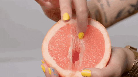 Finger touching an open tangerine