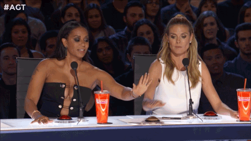 [Image description: A gif of two judges from America's Got Talent quickly placing their hand over a buzzer to say yes for a contestant.]