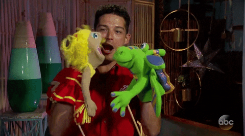 Gif of a man manning two puppets and having one puppet scream at the other.