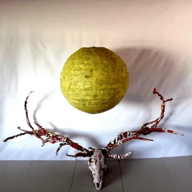 Yellow sphere hovering above an antlered skull