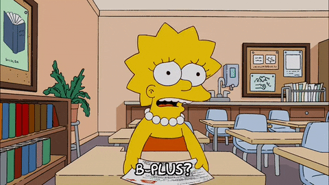 Lisa Simpson, disappointed, questions, "B-plus?" after receiving her grade on an assignment while sitting at her desk in class. 