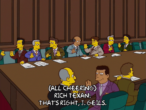 Simpsons high-fiving in a board meeting room.