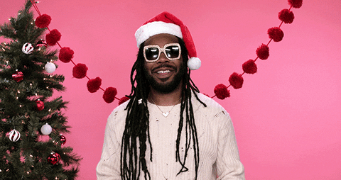 Gif of music producer Dram in front of Christmas tree with Santa hat