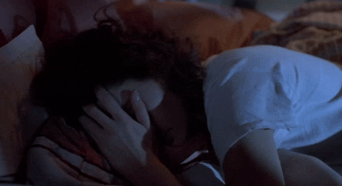 Gif of a woman screaming and waking up from a nightmare.