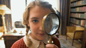 girl looking through a magnifying gif