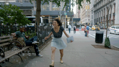 Happy girl skips through New York streets