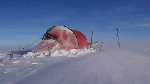a well in-tact tent set up in Antarctica while a strong wind blows