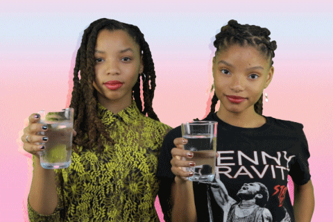 a GIF of Chloe and Halle giving the camera a glass of water
