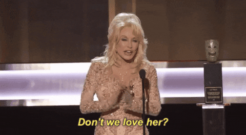 Dolly Parton applauding on stage.