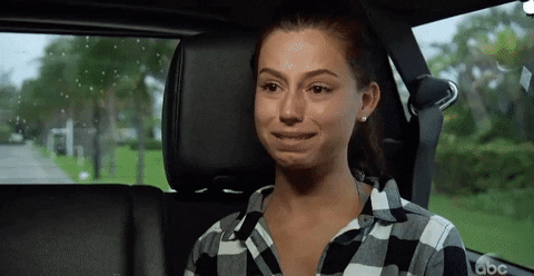 Gif of a woman crying in the car.