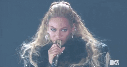 Beyonce giving the money gesture, more commonly known as the "Pay Me" gesture, is signalled by repeatedly rubbing one's thumb over the tip of the index finger and middle finger. 