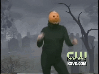 Man with pumpkin mask dancing