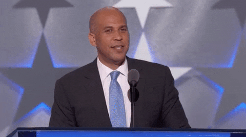 Cory Booker wipes off sweat from his forehead with a handkerchief on the DNC stage