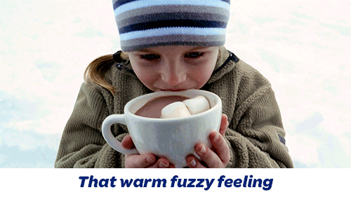 A girl sipping hot chocolate above the caption 'that warm fuzzy feeling'