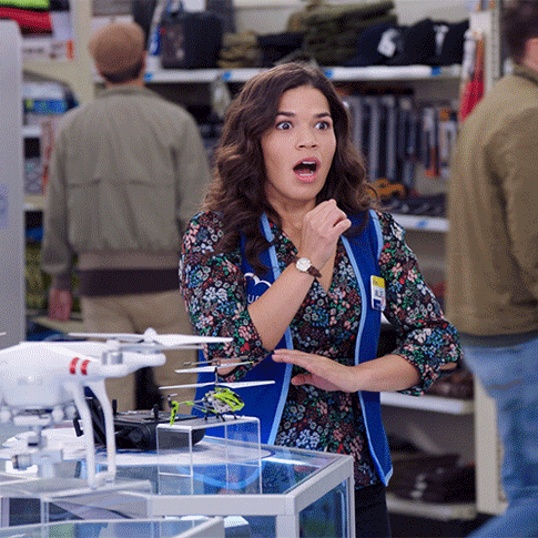 A GIF of Amy from Superstore jumping up and saying 