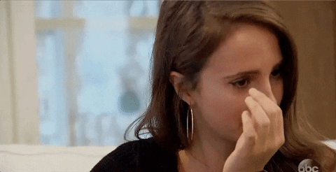 Gif of a woman wiping away a tear.