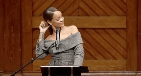 Rihanna frente a un micrófono sonriente y orgullosa