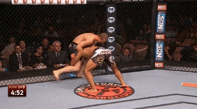 Kevin Lee wrestles Jesse Ronson against the cage